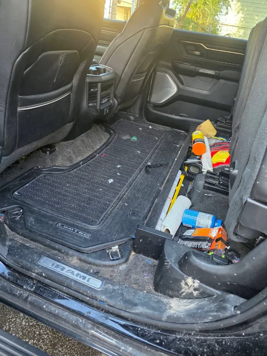 Before: Ram rear cabin floor covered in debris, dirt and loose items
