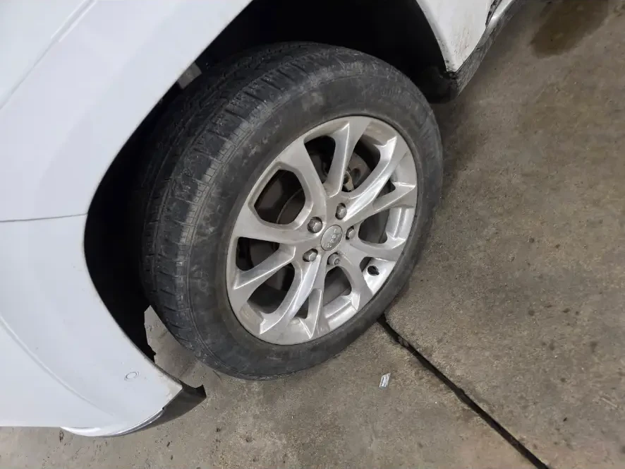 Before: dull, dusty Jeep wheel and tire