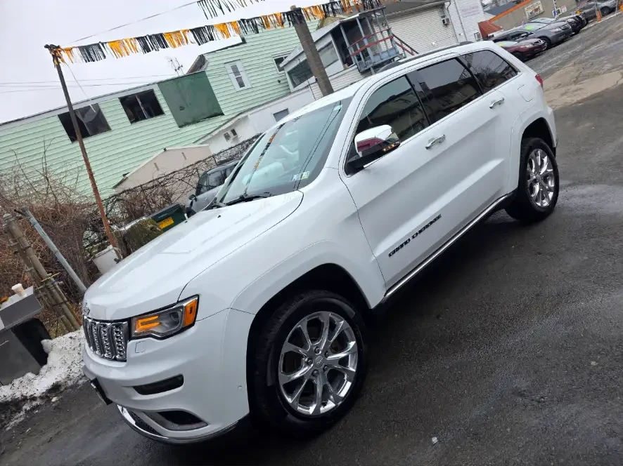 After: white Jeep Grand Cherokee clean and glossy outdoors